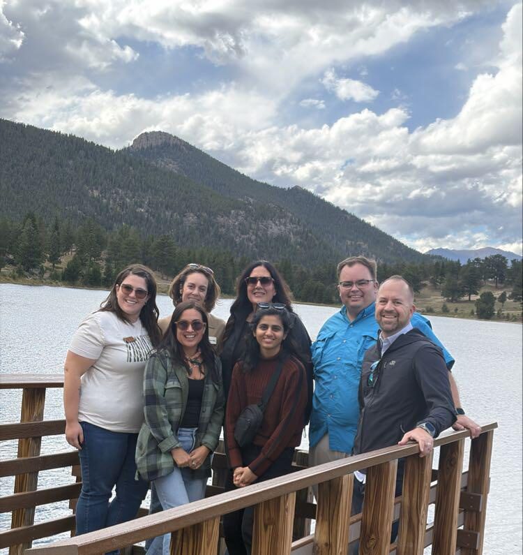 Photo of a group of Friends Alliance Members in front of a lake and mountains at Rocky Mountain National Park.